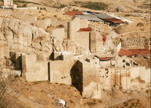 Ancient Mountain Fortress Ruins in Desert Landscape