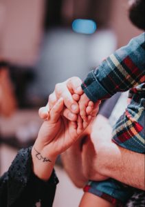 a couple holding hands while holding each other