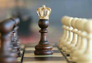 A brown pawn with a crown stands prominently on a chessboard, symbolizing strategic play.