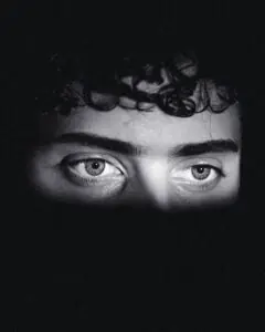 Intense black and white close-up of eyes conveying emotion and mystery.