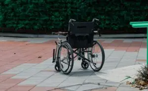 black bicycle parked beside green wall