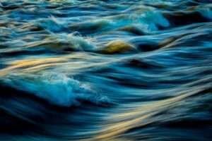 Capture of flowing ocean waves in motion, showcasing the vibrant colors and dynamic movement of water.