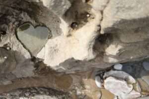 a heart shaped hole in a rock wall