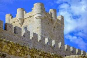 Stone castle tower in Villena, Spain with blue sky. A perfect depiction of historic architecture and tourism.