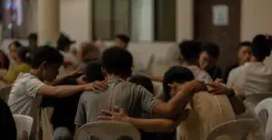 A group of people sitting around each other