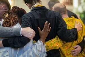 a group of people hugging each other