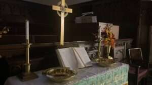 a table with a cross and a book on it